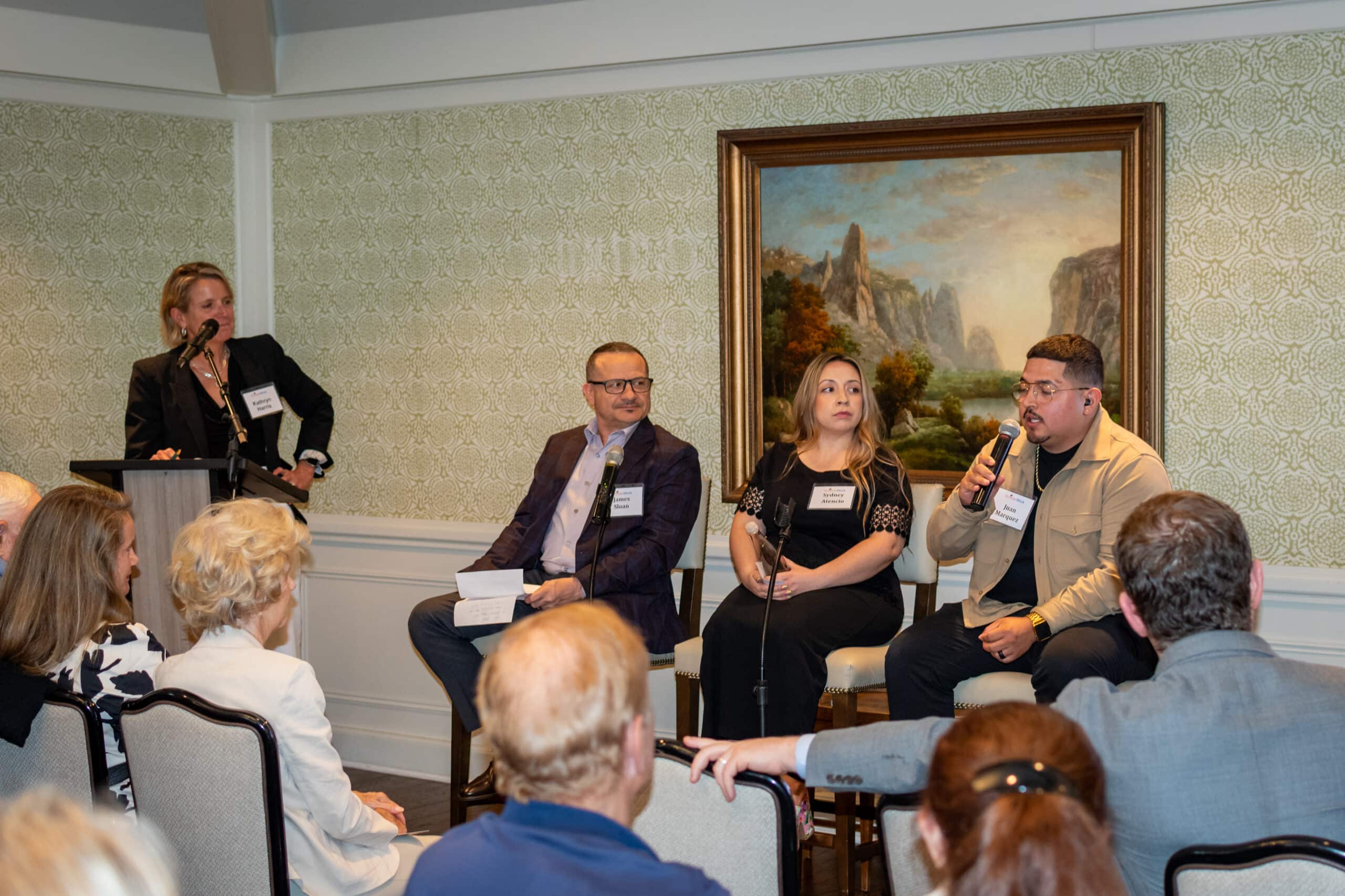 Juan Marquez speaking on a panel of ActivateWork graduates at a donor event in 2025