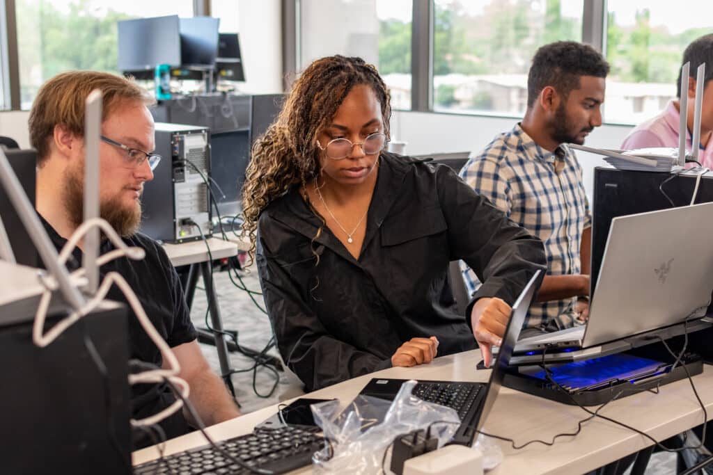 ActivateWork learners learning about LANs and routers during a hands-on lab project